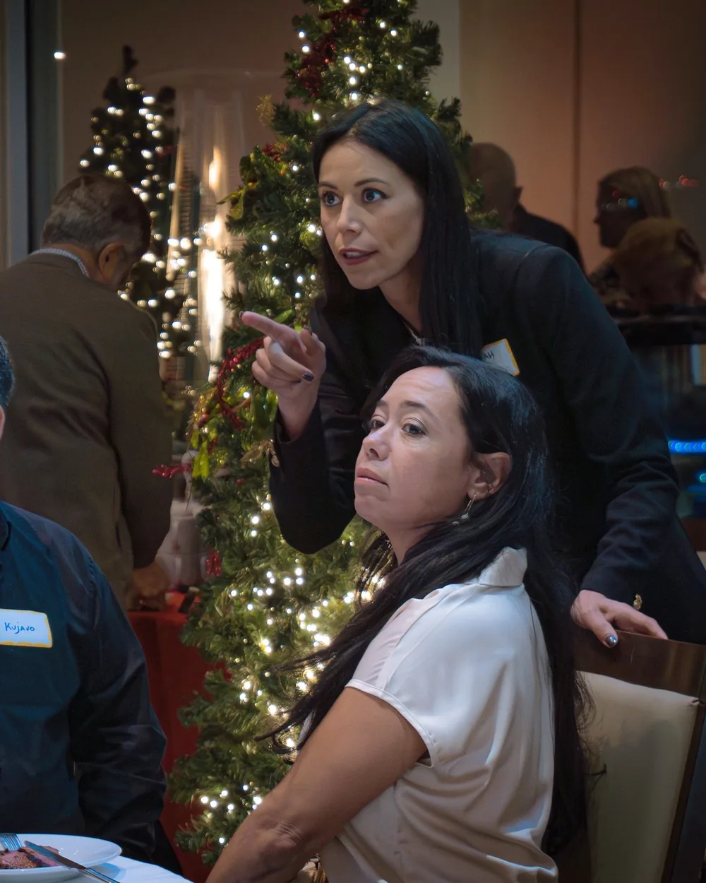 Rebekah Samples talking with guests at a dinner table