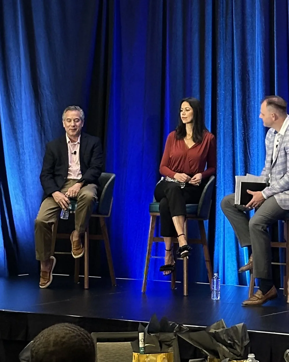 Rebekah Samples speaking on a panel on stage
